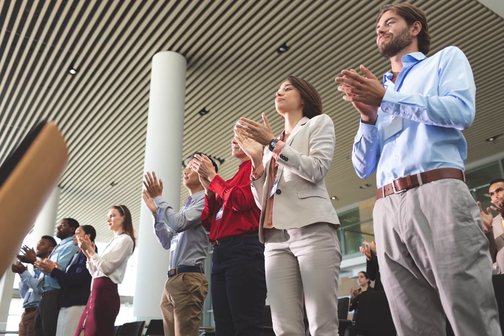 business-people-clapping-while-standing-at-a-busin-2023-11-27-05-01-12-utc.jpg